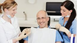 Senior dental patient smiling after getting dental implants